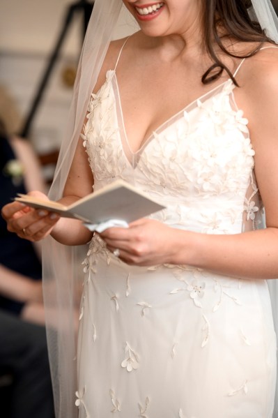 Up close detail of brides hands holding booklet